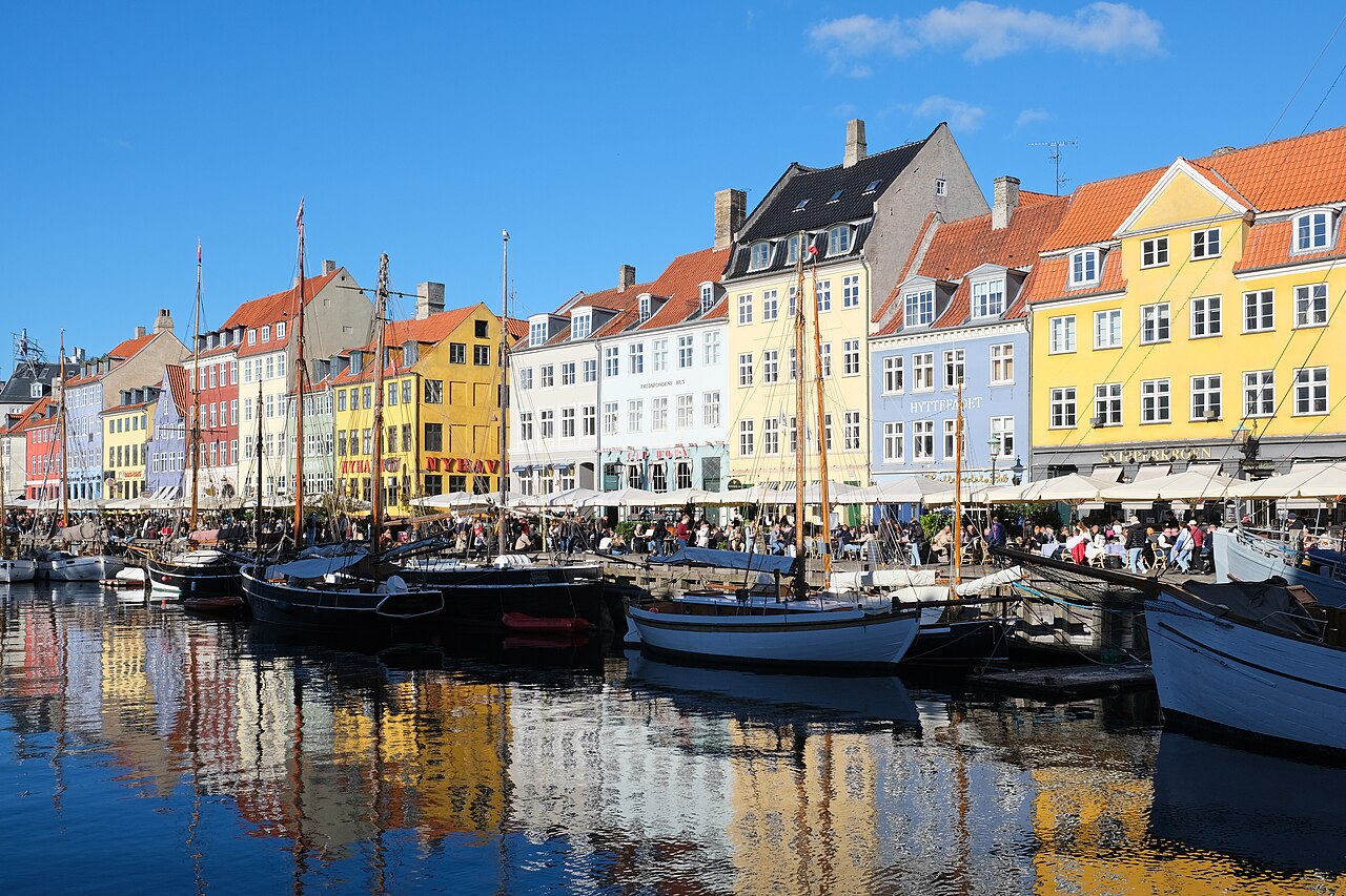 Colourful buildings and moored boats along the Nyhavn canal in Copenhagen